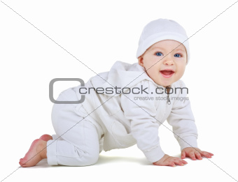 Child in a white suit crawls
