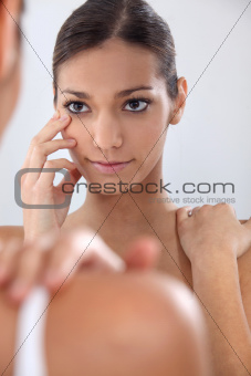Woman putting in her contact lenses