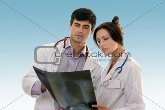 Two doctors conferring over x-ray results