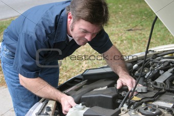 Auto Mechanic Checks Engine