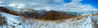 First winter snow in autumn mountain and ski lift