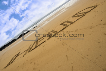Hello inscribed on a sandy beach