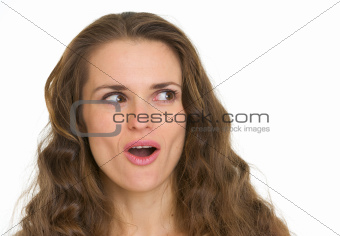 Portrait of surprised woman looking on copy space