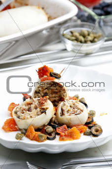 baked sepia with tomatoes and black olives filled with pearl barley risotto