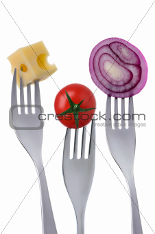 tomato cheese and onion on forks against white background