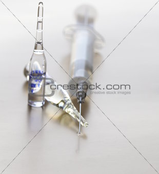Close-up of vaccine drop on syringe needle