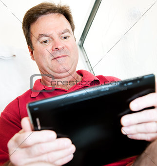Man in Bathroom with Tablet PC