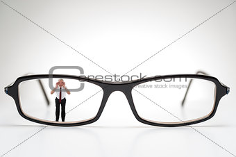 Diminutive elderly man peering through spectacles
