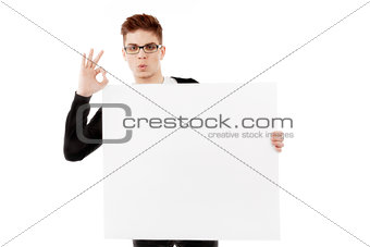 Young man with a blank baner