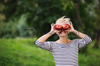 happy young girl holding red appples