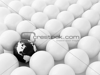 Spheres of cream color and black globe as a background