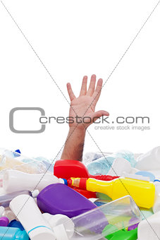 Man drowning in plastic recipients pile