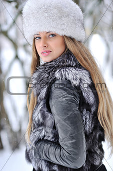 Fur fashion hat. Beautiful girl in furry hat. Winter woman portr