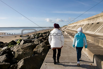mother and daughter on beach promenade
