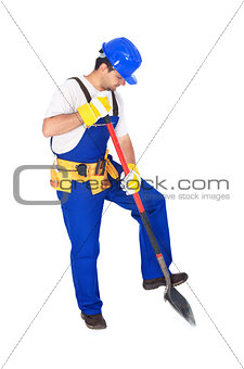 Worker in uniform working with a shovel