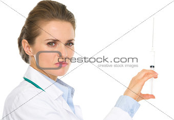 Serious medical doctor woman holding syringe