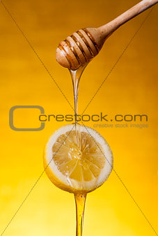 Close-up shot of honey flowing on lemon 