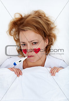 Lovesick woman with thermometer in bed