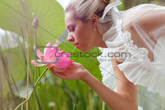 happy bride smelling a lotus
