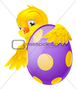Cute chick and painted chocolate Easter egg