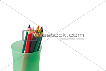 colored pencils for children in green glass