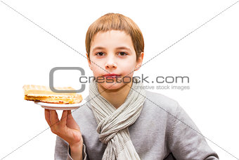 Portrait of a cute boy offering a waffle - isolated on white