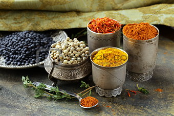 various spices (turmeric, paprika, saffron, coriander) in metal bowls