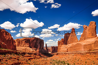 Arches National Park landscape view with blue sky and white clou
