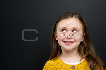 Smart young girl stood infront of a blackboard