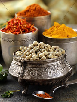 various spices (curcuma, paprika, saffron, coriander) in metal bowls