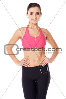 Beautiful athletic woman listening to music