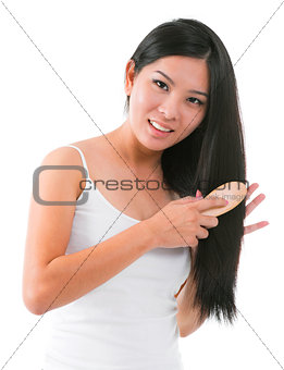 Asian girl combing hair