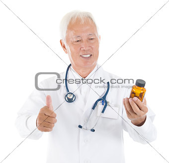 Asian senior medical doctor holding a bottle of pills