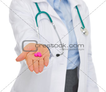 Closeup on medical doctor woman giving tablets