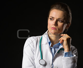 Portrait of thoughtful medical doctor woman looking on copy spac