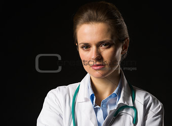 Portrait of confident medical doctor woman isolated on black