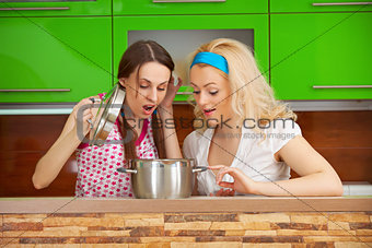Girls looking at a meal in a pot