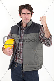 Angry builder waving fist