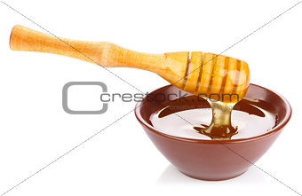 honey in pottery pan with dipper