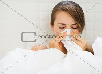 Woman with flu laying in bed