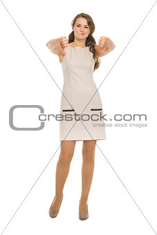 Full length portrait of young woman showing thumbs down