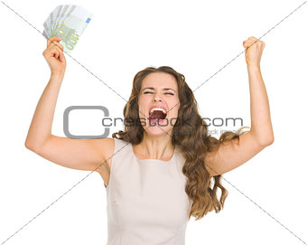 Happy young woman with euro banknotes rejoicing success