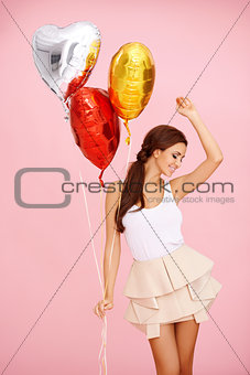 Dancing brunette with balloons