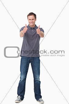 Smiling young man giving thumbs up