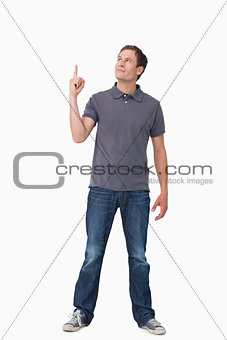 Young man pointing and looking up