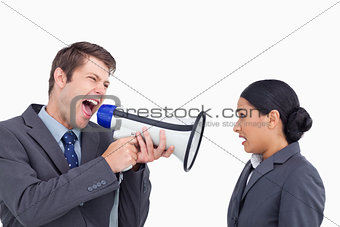 Close up of salesman with megaphone yelling at colleague