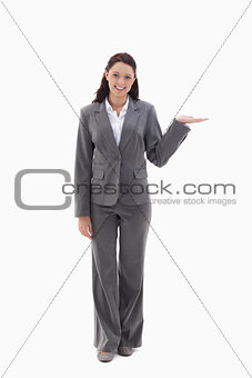 Businesswoman smiling and presenting a product