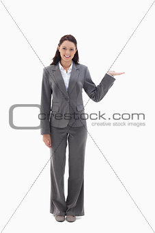 Smiling businesswoman and presenting a product