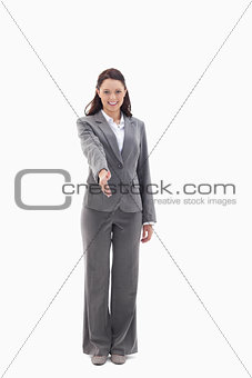 Businesswoman smiling and holding out her hand