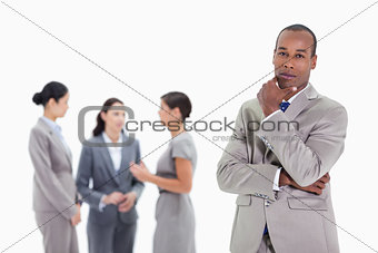 Thoughtful businessman with co-workers